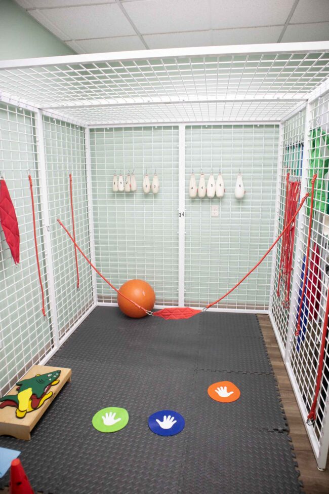Kid's Creek Therapy - Play area, staircase, and hanging jungle gym in the Kid's Creek office