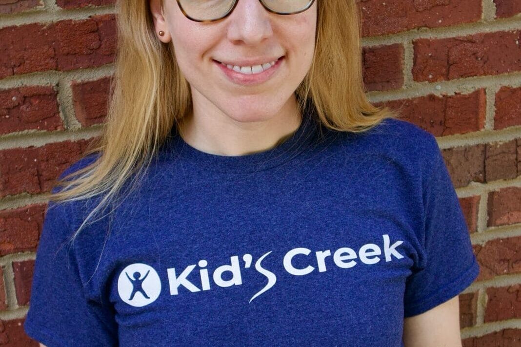 Kid's Creek Therapy - Employee poses for headshot with brick wall in background