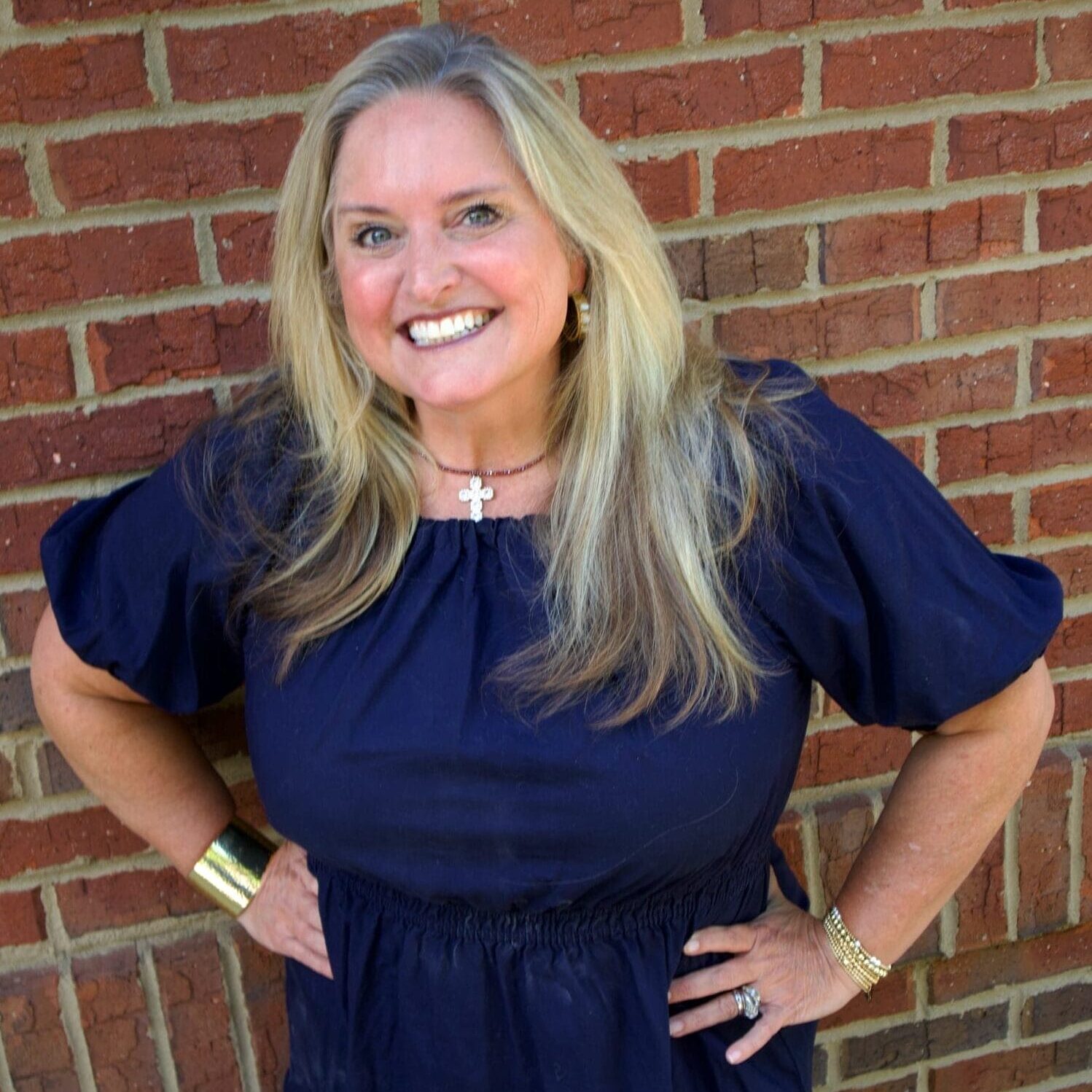 Kid's Creek Therapy - Employee poses for headshot with brick wall in background