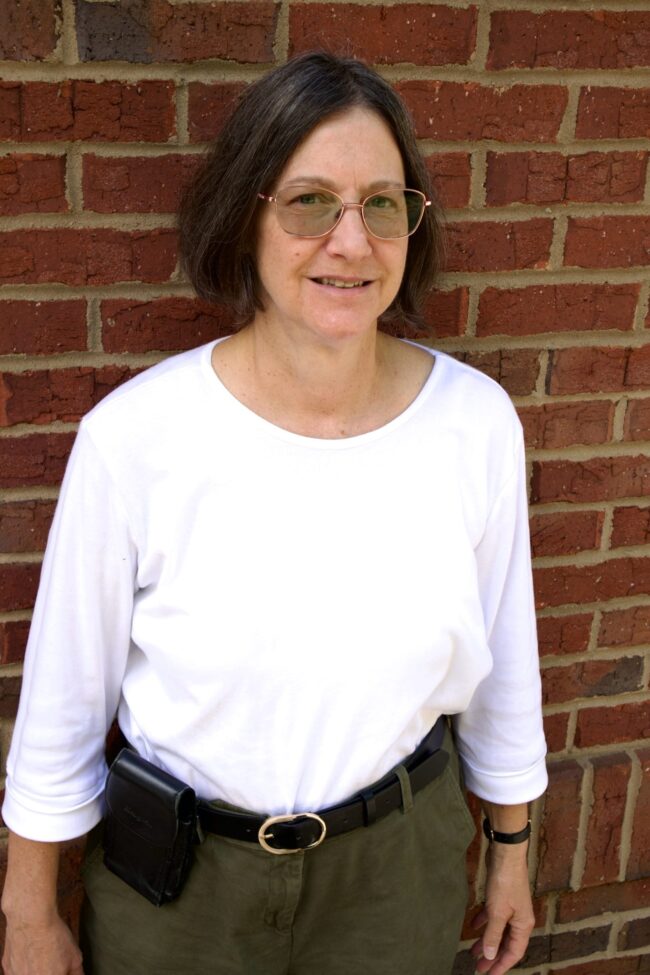 Audrey Kid's Creek Therapy - Employee poses for headshot with brick wall in background