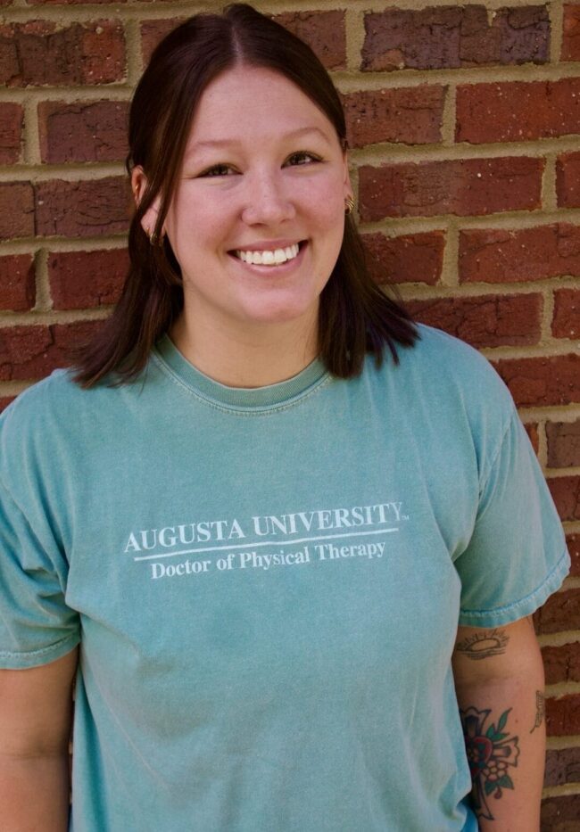 Madison Kid's Creek Therapy - Employee poses for headshot with brick wall in background