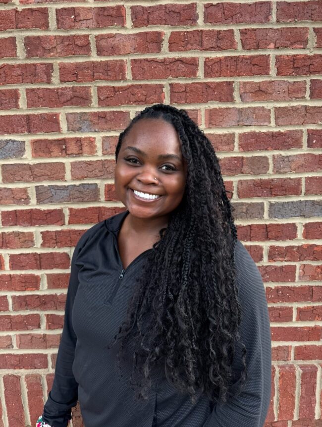 Sierra Kid's Creek Therapy - Employee poses for headshot with brick wall in background